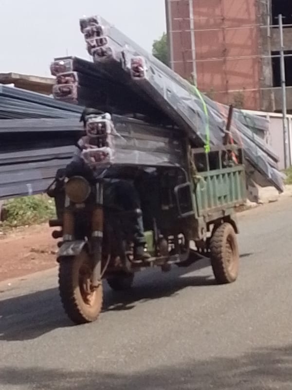 Heavily loaded vehicles navigate busy Tamale streets