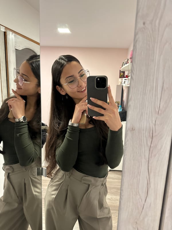 Woman takes mirror selfie while applying makeup in Bulgaria
