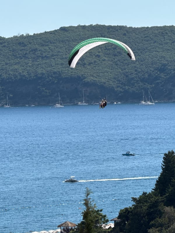 Paragliders ride thermals above the Adriatic coast at Boreti