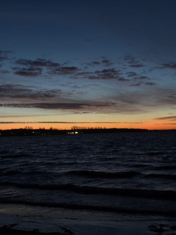 Sunset observed over water near Riga, Latvia