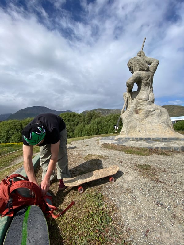 Tourist documents native monument statue in Ushuaia, Argentina