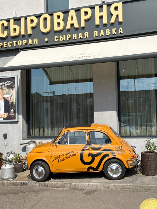 Orange Fiat 500 parked outside cheese dairy in Krasnoyarsk
