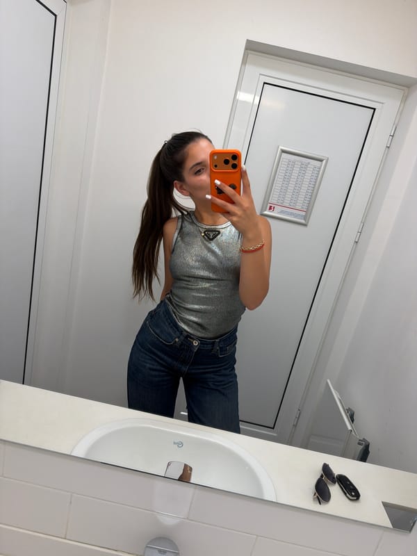 Woman takes bathroom mirror selfies in Pernik, Bulgaria