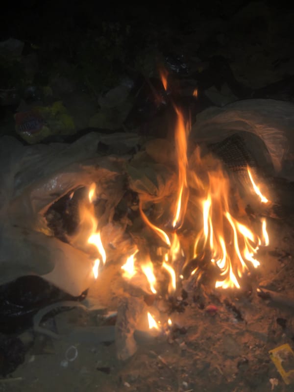 Trash fires burn across open area in Nigeria