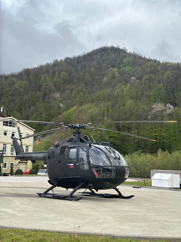 Dark helicopter parked at building complex in Estosadok, Russia