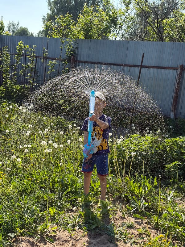 Child plays with water toy in Foki, Russia