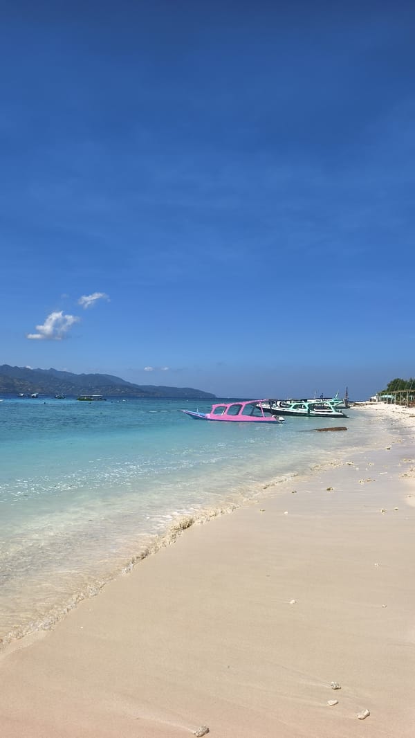 Tropical beach scene with boats documented in Indonesia