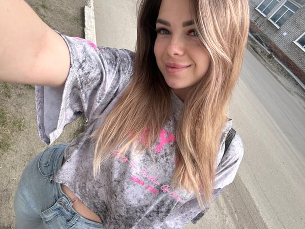 Woman takes selfie in tie-dye sweatshirt