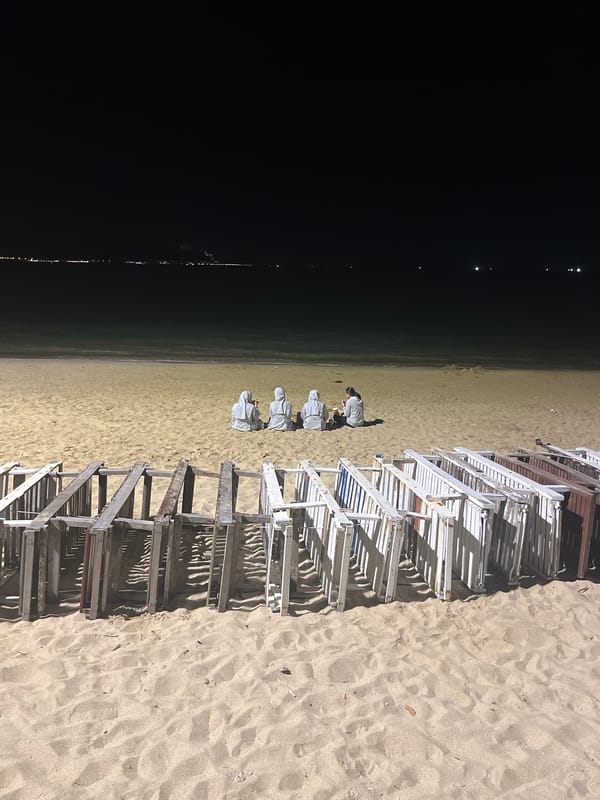 Nighttime coastal scenes show empty beach chairs, illuminated skyline