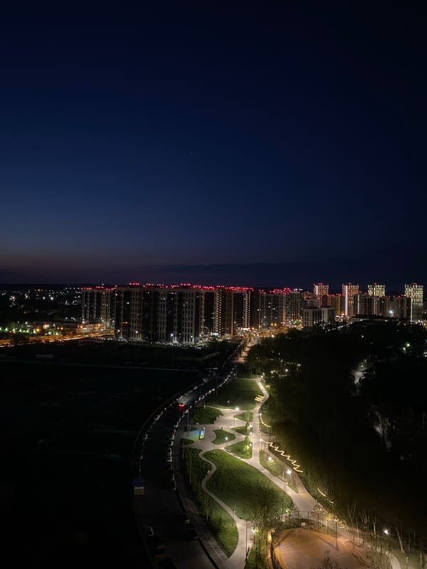 Nighttime aerial view captures illuminated Kazan cityscape