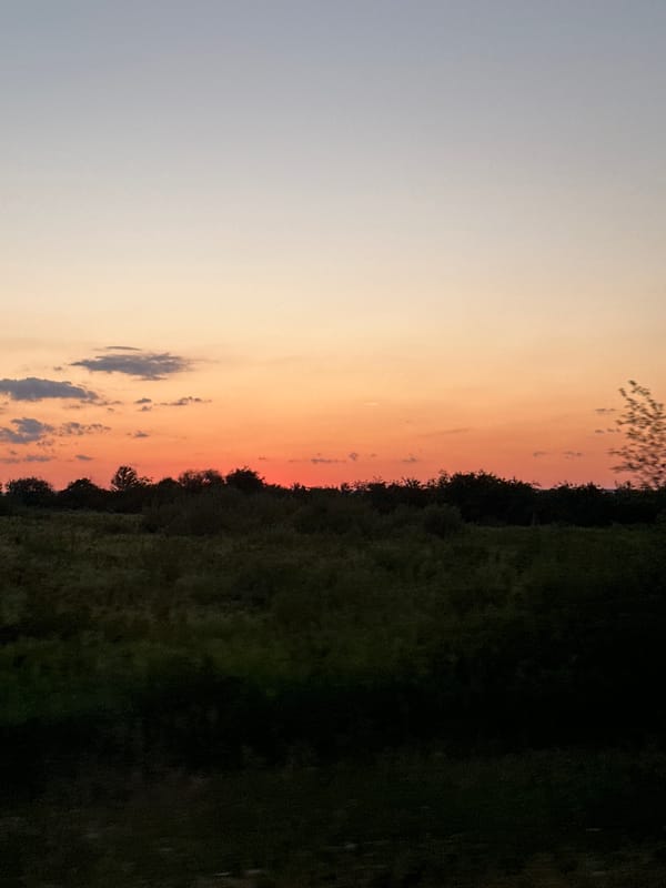 Warm summer sunset over rural countryside near Vynnyky, Ukraine
