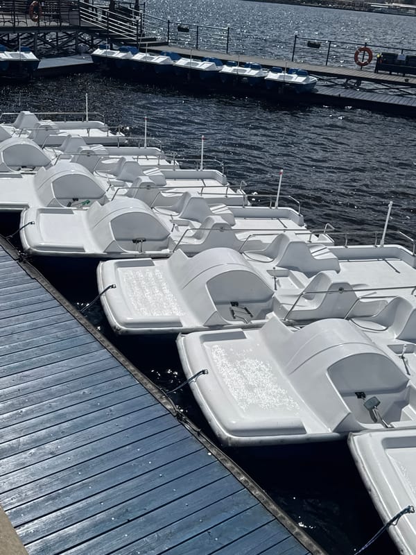 Morning at Izhevsk waterfront shows pedal boats and amusement rides