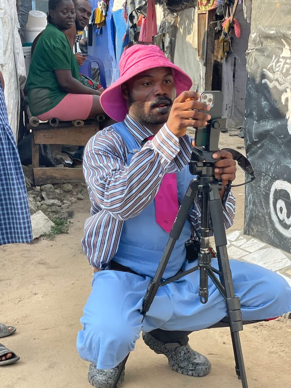 Man films with smartphone on tripod in Iranla, Nigeria