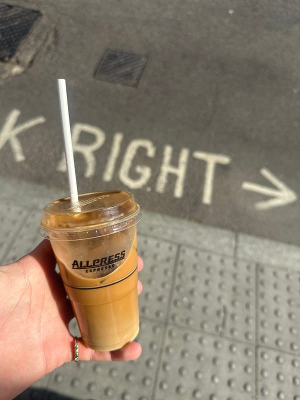 Coffee moment captured on marked London sidewalk