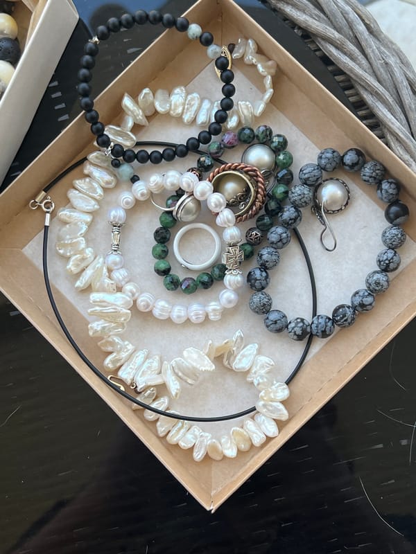 Handmade jewelry and sleeping cats at a Sochi market stall