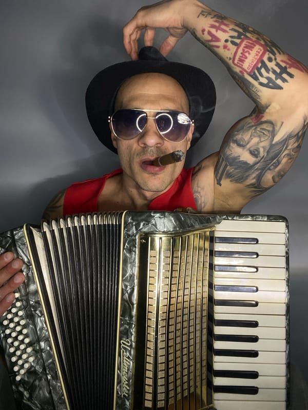 Tattooed accordion player performs with cigar in Pleven, Bulgaria