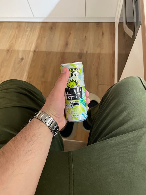 Person holds NEU energy drink in Sofia evening