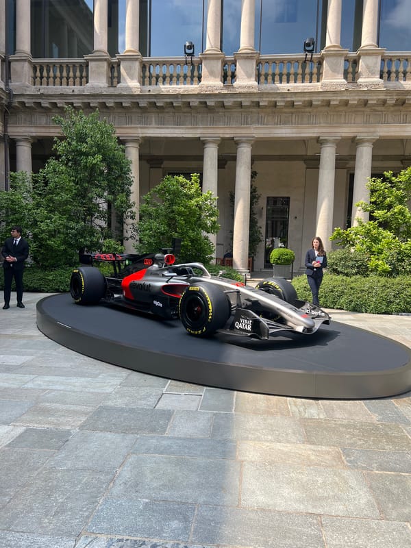 Formula 1 car displayed outside classical Milan building