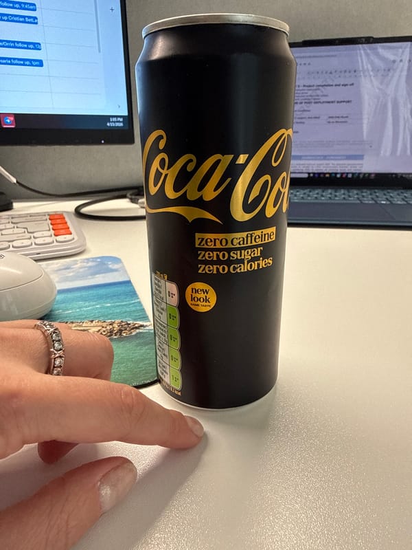 Desk snack moment captured with Coca-Cola can in Riga