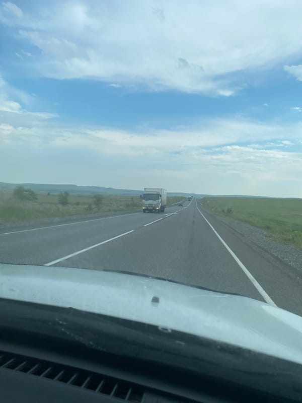 Vehicle travels wet rural roads through Krasnyi Kamen countryside