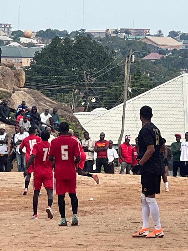 Pickup soccer match on a dusty field in Jos, Nigeria