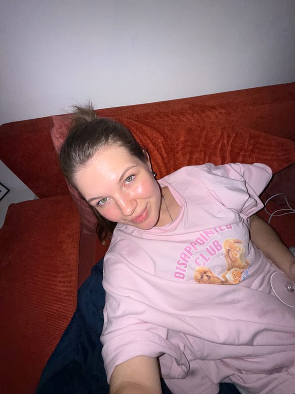 Woman takes selfie on orange sofa in Belgrade suburb