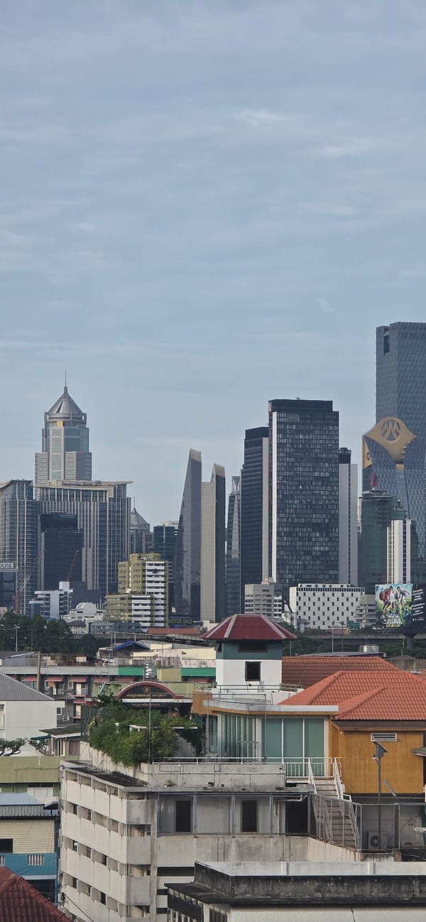 Bangkok skyline under an overcast sky, seen from above.
