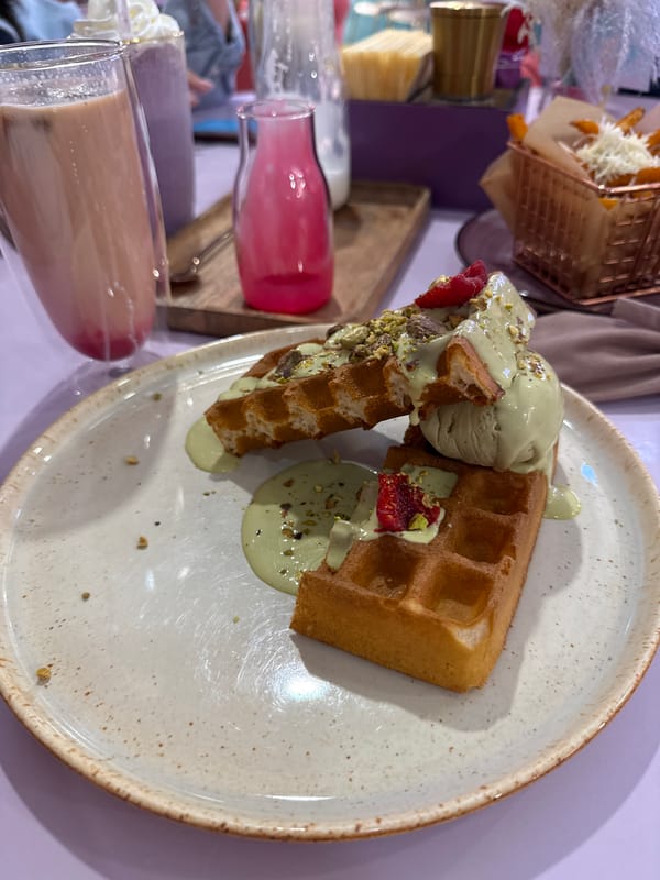 Family shares green pistachio desserts at Vladivostok cafe