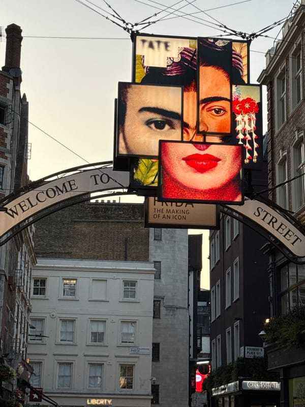 Welcome archway marks a London street entrance on a cloudy day