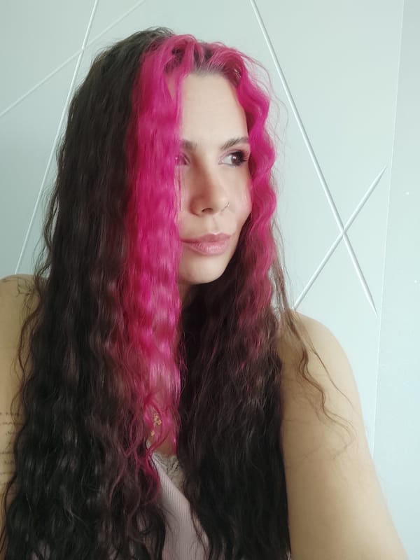 Close-up and profile shots featuring bold pink-highlighted hair