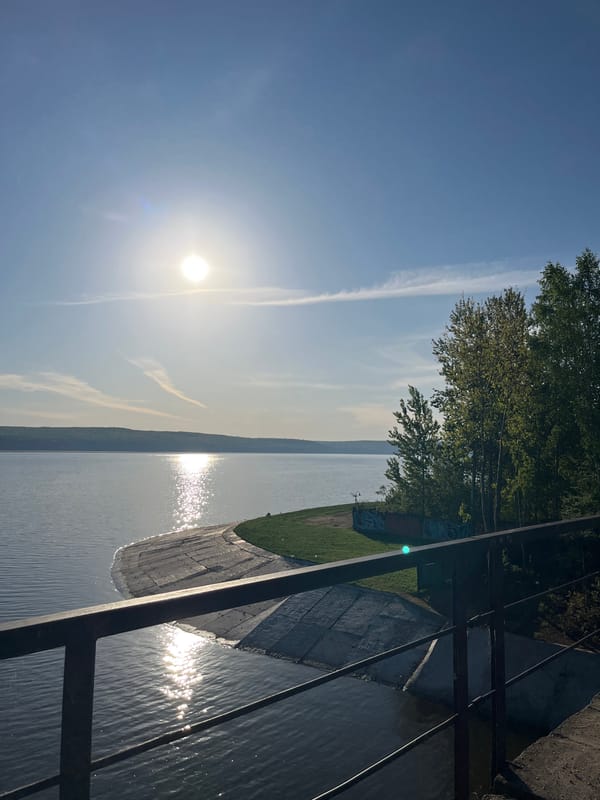 Cyclist and boaters enjoy sunny morning on Kama River