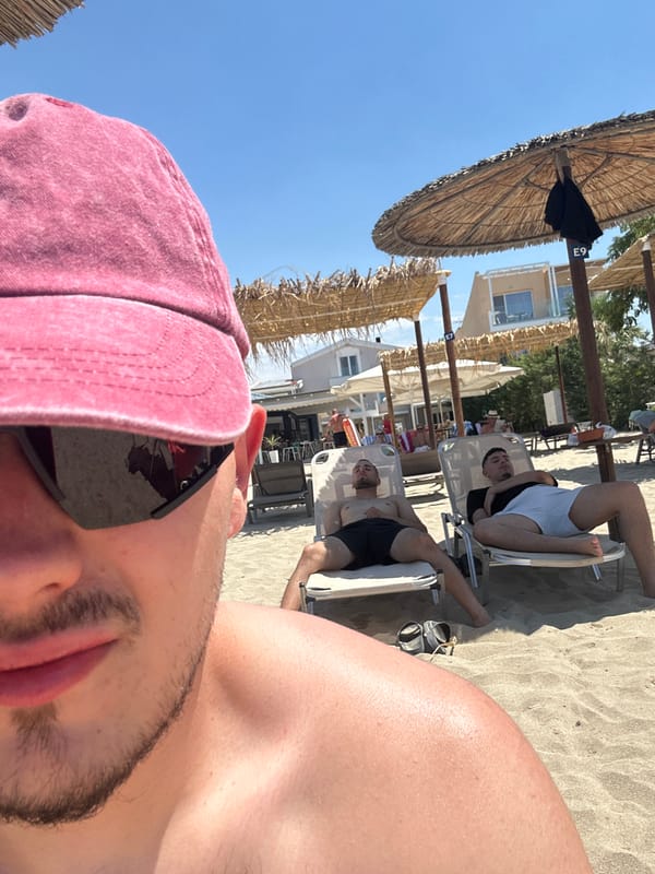 Lazy beach day under straw umbrellas, selfies and lounging