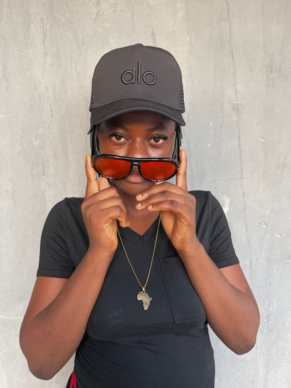 Woman poses for photos in Badagry wearing Africa pendant