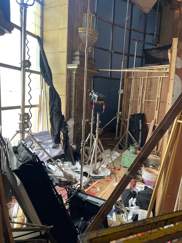 Inside a dressed Mumbai film set with chandeliers and flowers