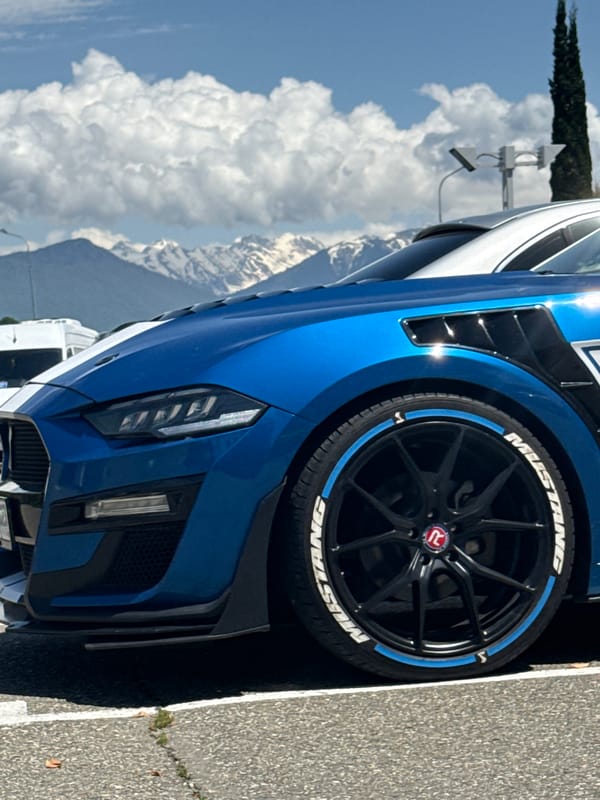 Blue Mustang spotted parked near modern building in Sochi