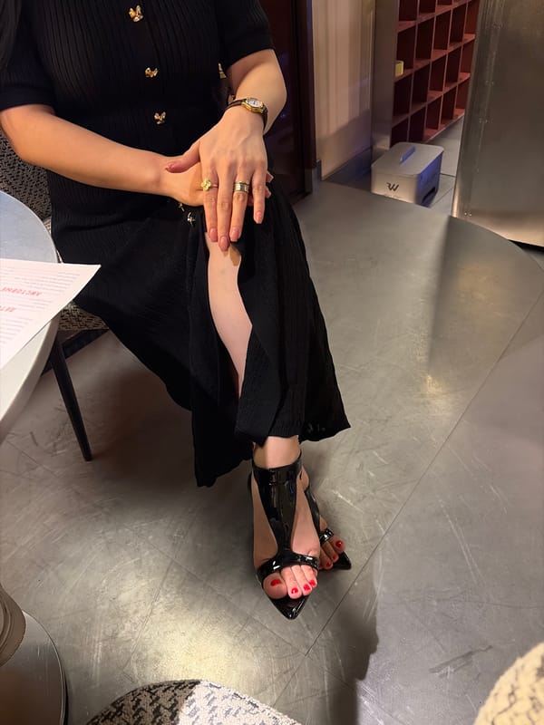 Woman in black dress visits Astana bakery, handles cosmetics