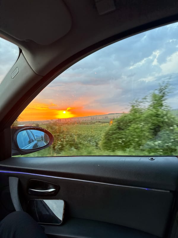 Sunset breaks through dark clouds over rural Probuda, Bulgaria