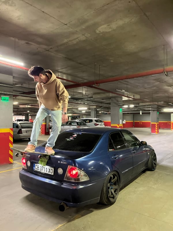 Young man performs skateboard stunts on cars in Sofia garage