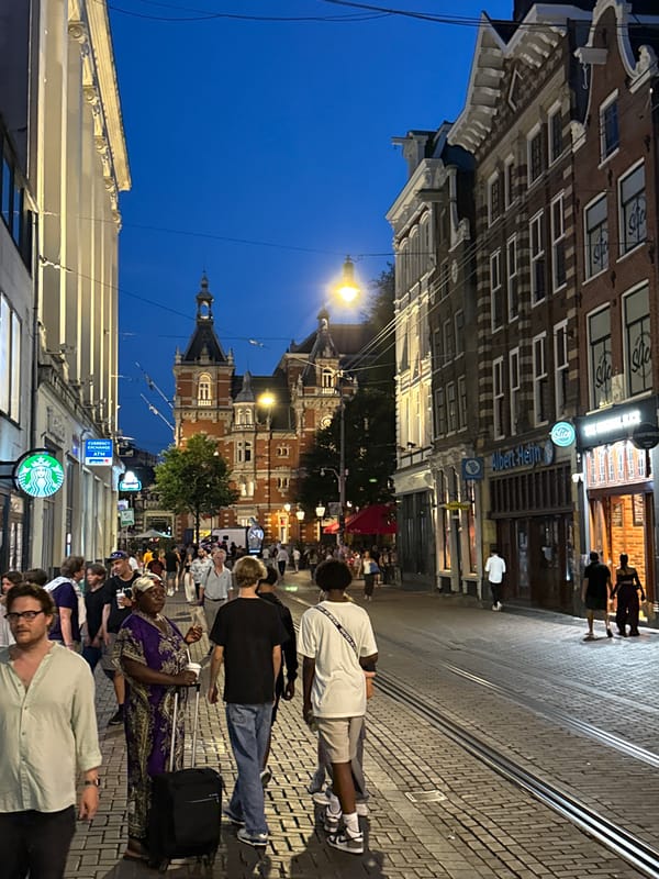 Dusk activity around Amsterdam Centraal Station on a summer evening