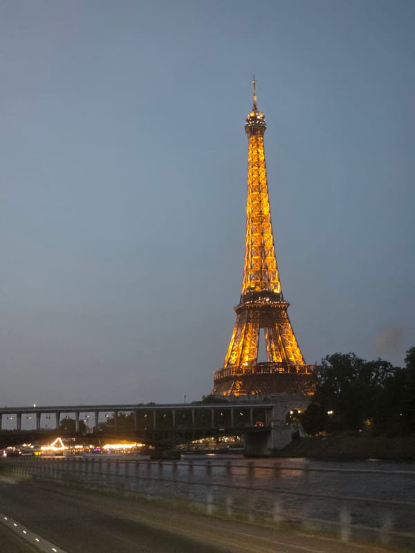 Eiffel Tower glowing gold at dusk, Paris