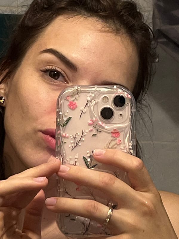 Woman takes selfies with floral phone case in Shushary