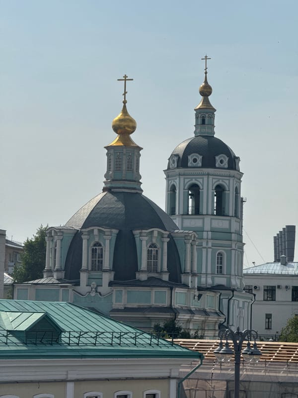 Soviet skyscraper and tsarist-era church side by side in Moscow
