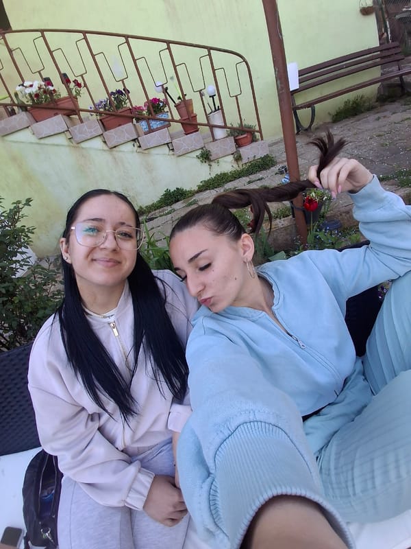 Friends enjoy spring afternoon with drinks and dog in Bulgaria