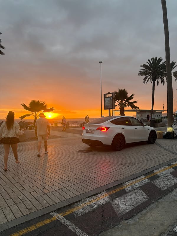 Couple shares sunset kiss on Adeje promenade