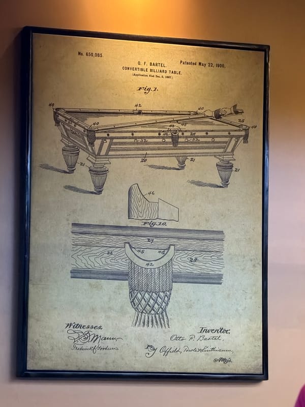Marrakesh interior displays vintage billiard table patent alongside trophies