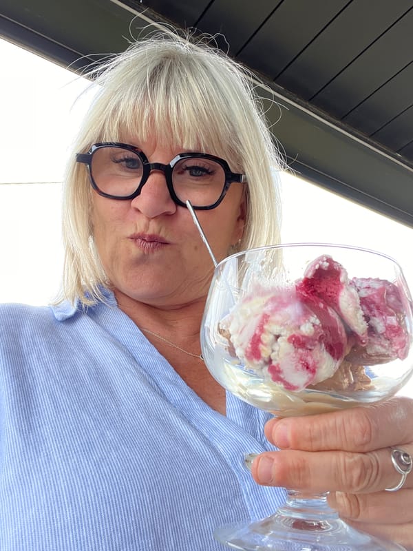 Woman enjoys ice cream during afternoon treat in French town
