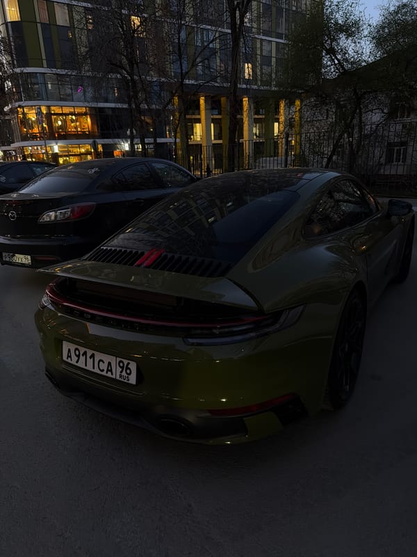 Green Porsche spotted parked on Yekaterinburg street at dusk
