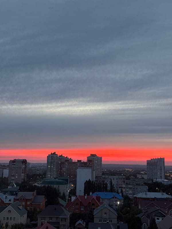Orenburg skyline glows under a vivid red summer sunset