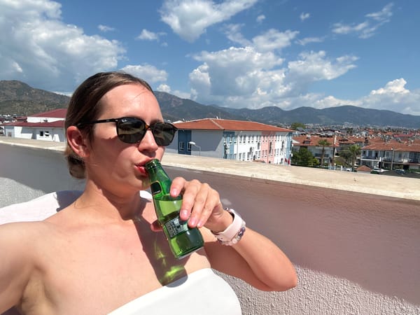 Woman enjoys morning routine on Fethiye balcony