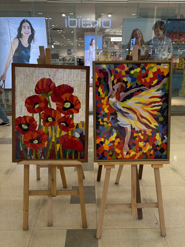 Woman takes selfie near mosaic art display in Yerevan